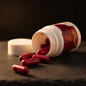 Open Ultra Bann bottle with red capsules